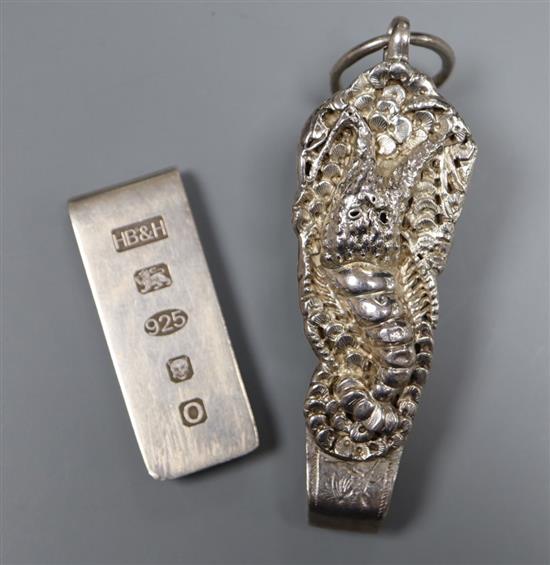 A silver money clip and a white metal chatelaine clip.